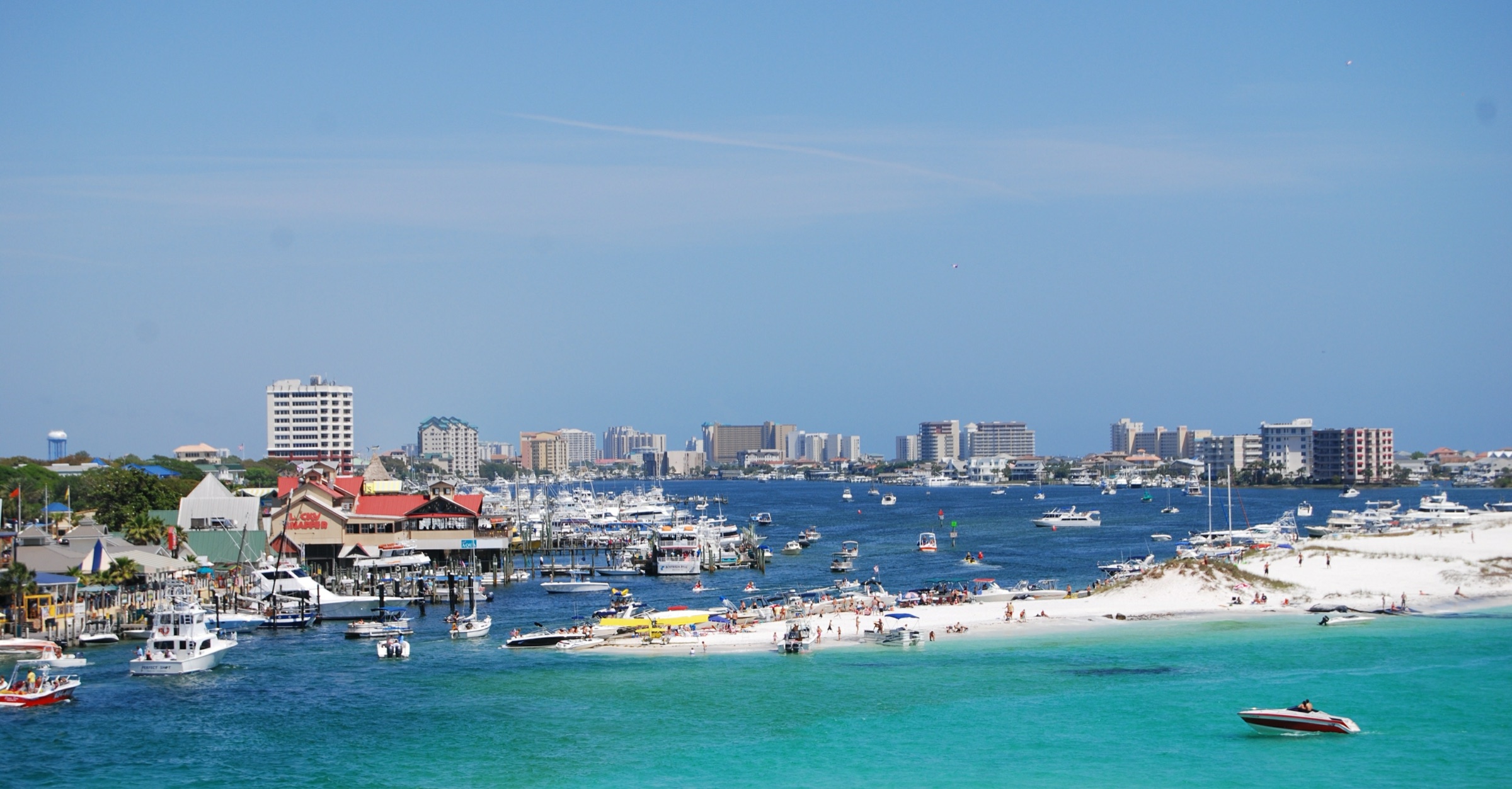 Destin Harbor with the charter fishing fleet and the East Pass to the Gulf