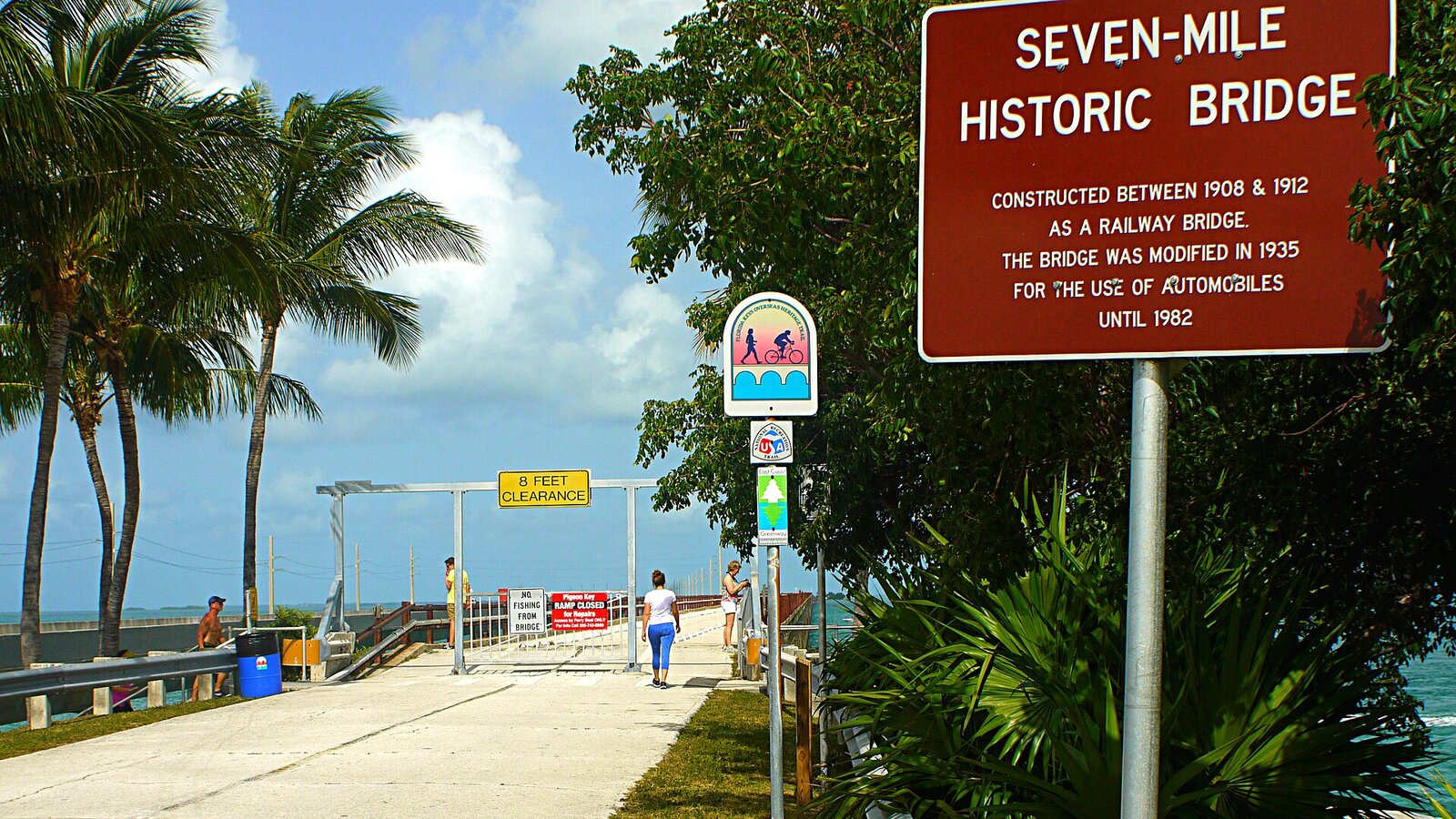 Cyclist on the old Seven Mile Bridge with turquoise water below in the Florida Keys
