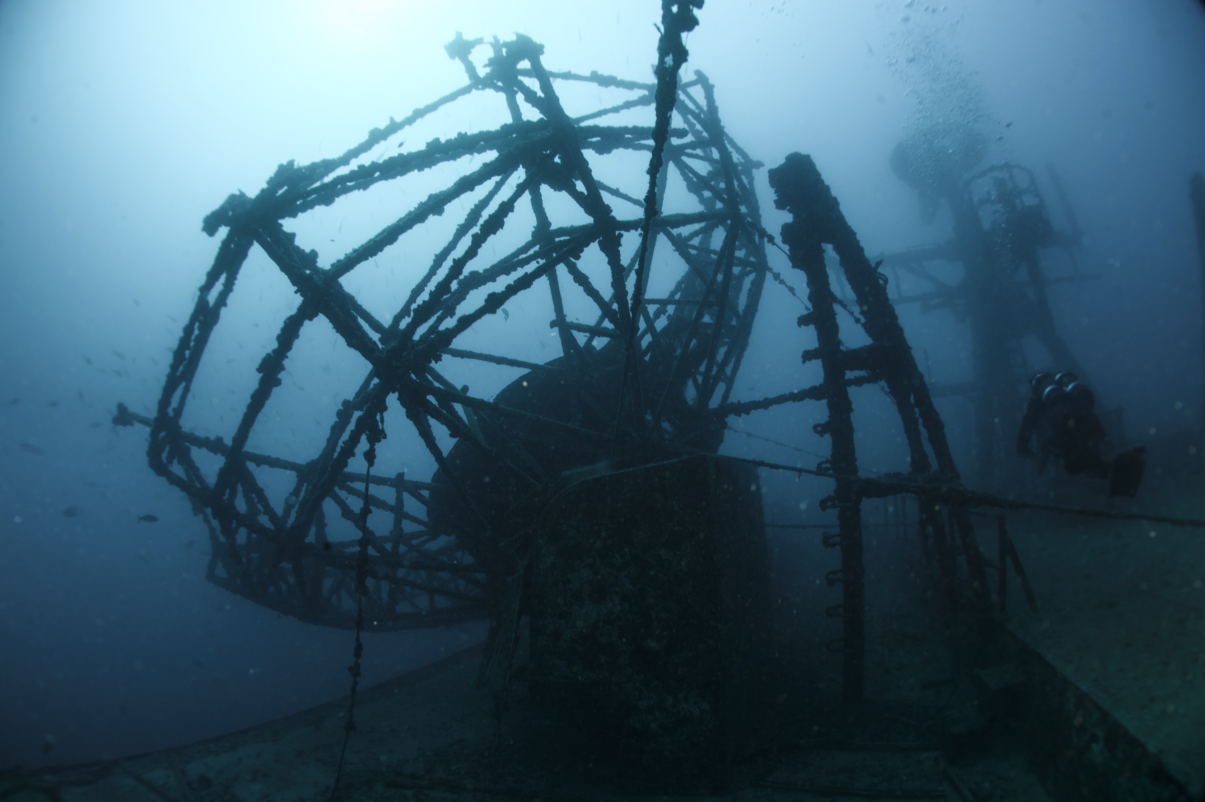 A scuba diver hovers above the wreckage of the USNS General Hoyt S. Vandenberg artificial reef in the blue waters off Key West, Florida
