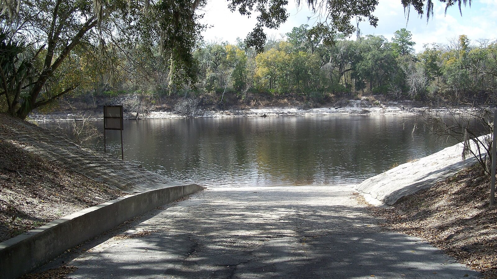 Canoe on tannic Suwannee River with cypress trees draped in Spanish moss